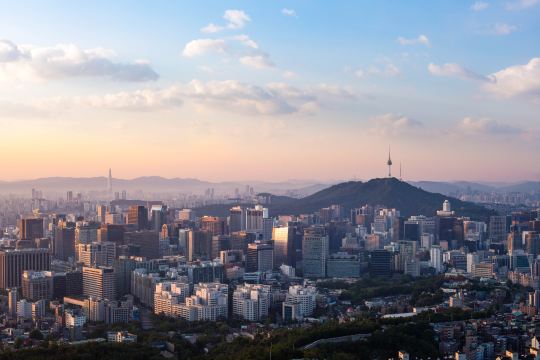Seoul skyline at sunset, with the N Seoul Tower on Namsan above the office towers of the city center