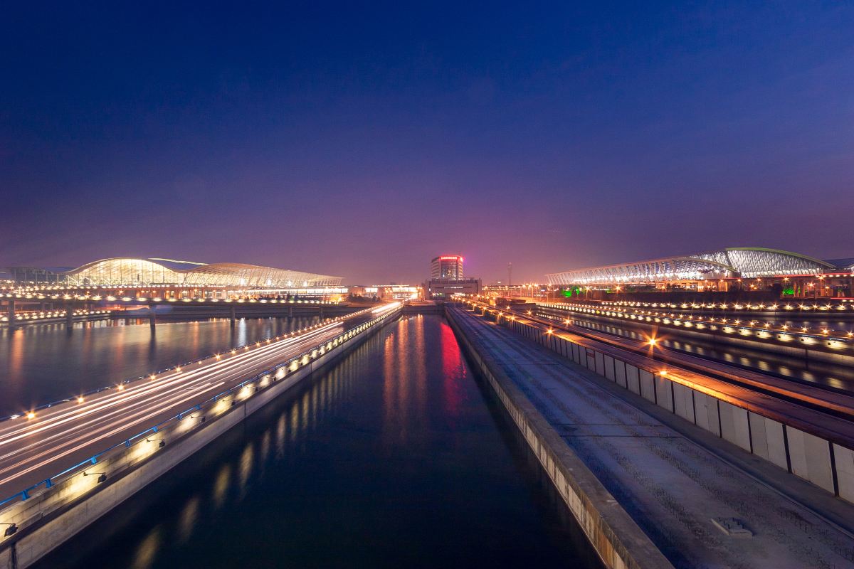 Airport terminal buildings and approach roads at dusk in Shanghai