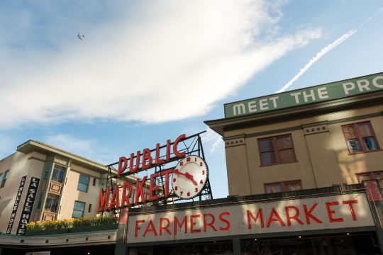 Public Market Center sign and clock above the Pike Place Market entrance in Seattle