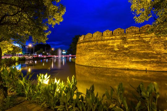 The old city moat and brick wall at night, a short walk from Chiang Mai hotels inside the walls