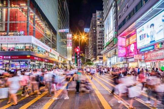Nathan Road crossing at night in Tsim Sha Tsui, near Hong Kong hotels