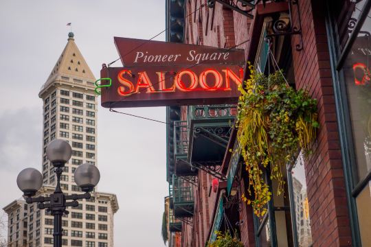 Pioneer Square Saloon sign with Smith Tower behind it in Seattle