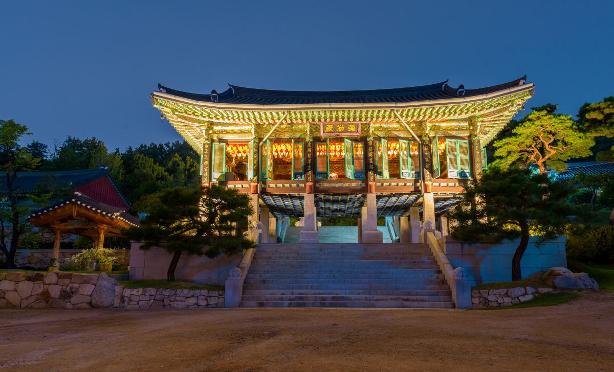 Bongeunsa Temple in Seoul's Gangnam district lit at night, with its painted wooden hall and stone steps