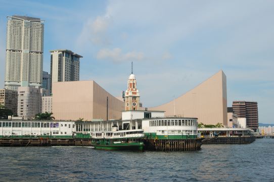Star Ferry pier in Tsim Sha Tsui with the clock tower of the former railway terminus and the harbour behind