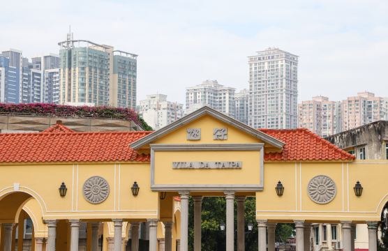The Taipa village archway in Macau, with the low buildings of the old village behind it