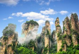 2-day 1-night · Group Tours · Zhangjiajie + Zhangjiajie National Forest Park + Tianmen Mountain National Forest Park · International Travelers - Discover Zhangjiajie in a flexible mini group for 2-6 people. This well-paced, all-inclusive journey features a 5-star international hotel, a business van, a complimentary eSIM for instant, seamless connectivity, and complimentary drone videography to capture unique aerial perspectives. Enjoy attentive, personalized service throughout your trip. Groups can start with just 2 travelers.