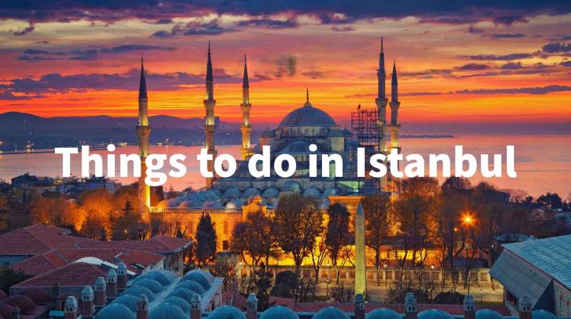 Istanbul's Blue Mosque illuminated at sunset, with the Bosphorus in the background and a sky of vibrant colours.