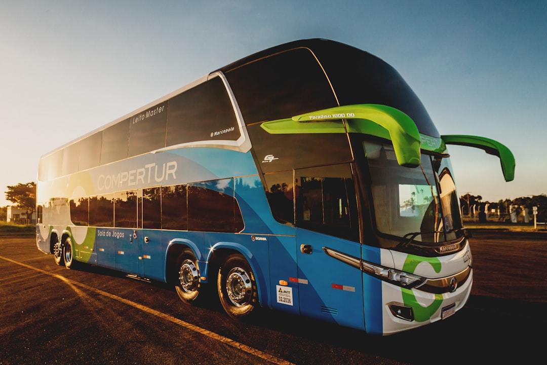 parked blue and black Compertur bus Via Unsplash (by Jonathan Borba)