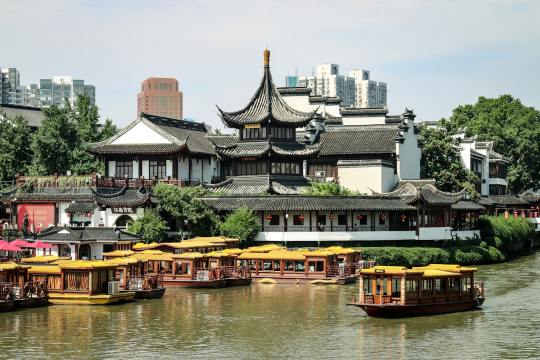 brown boat on river near green and brown building during daytime Via Unsplash (by Dendy)