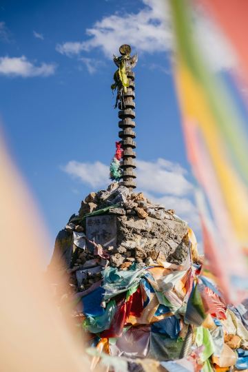 a man standing on top of a pile of trash Via Unsplash (by Rogan Yeoh)