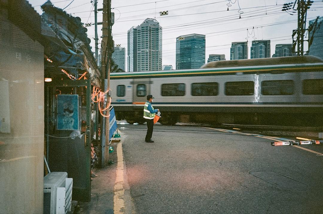 a group of people at a bus stop Via Unsplash (by Daniel Bernard)