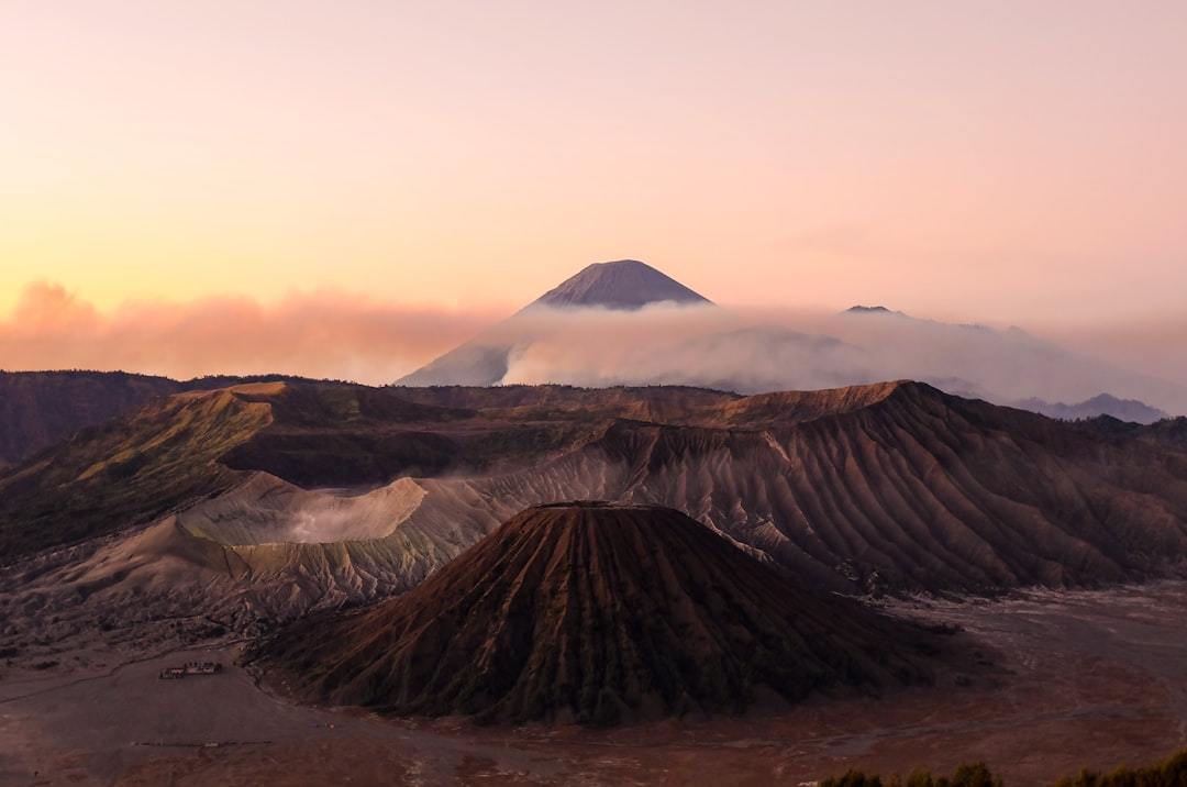 silhouette photo volcanoes during golden hour Via Unsplash (by Pukpik)