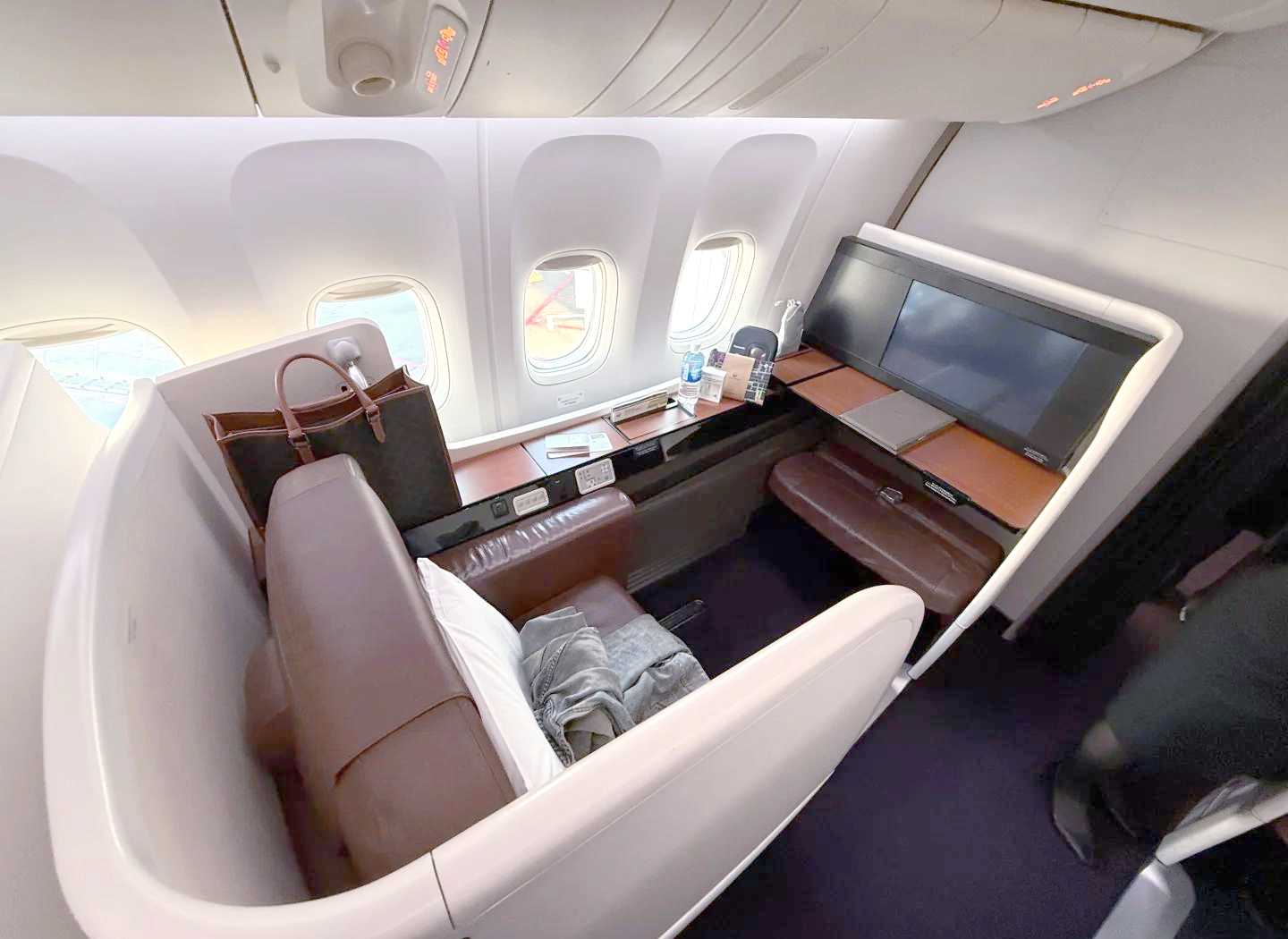 First Class seat with large monitor and private space