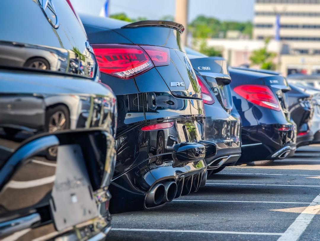 a row of parked cars in a parking lot Via Unsplash (by Koons Automotive)