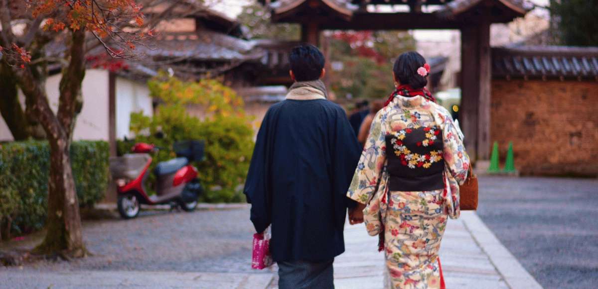 Pareja caminando por calle japonesa con vestimenta tradicional kimono en ambiente tranquilo