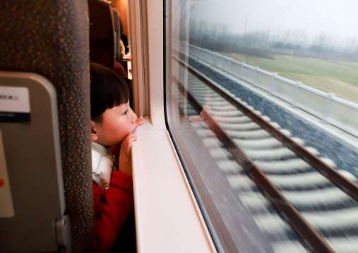 A little boy looking out of the window on China high-speed rail