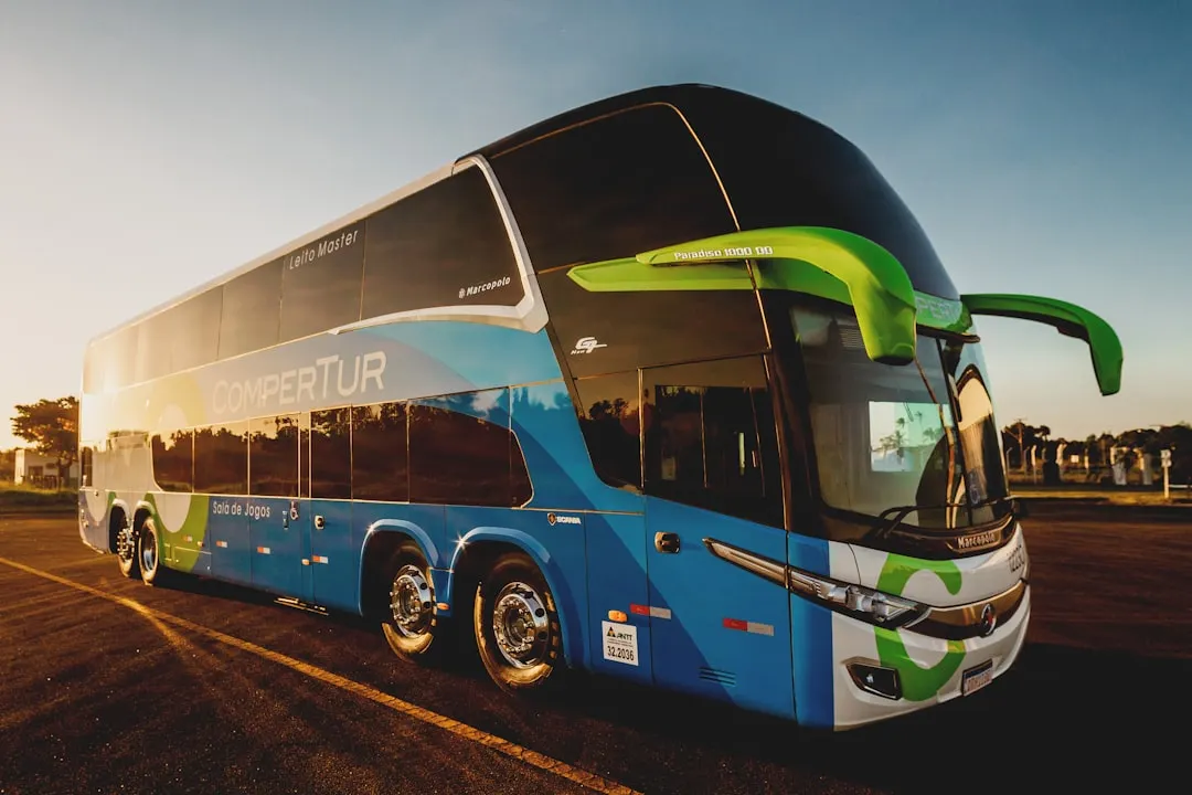 parked blue and black Compertur bus Via Unsplash (by Jonathan Borba)