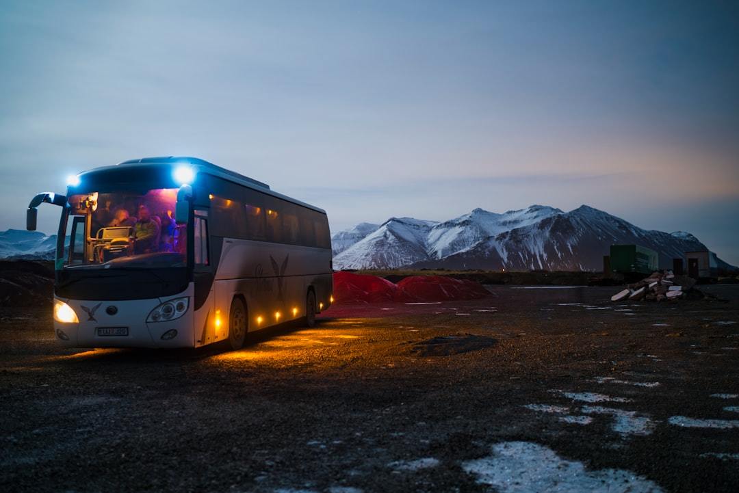 white and black bus running near the mountain Via Unsplash (by Juan Encalada)