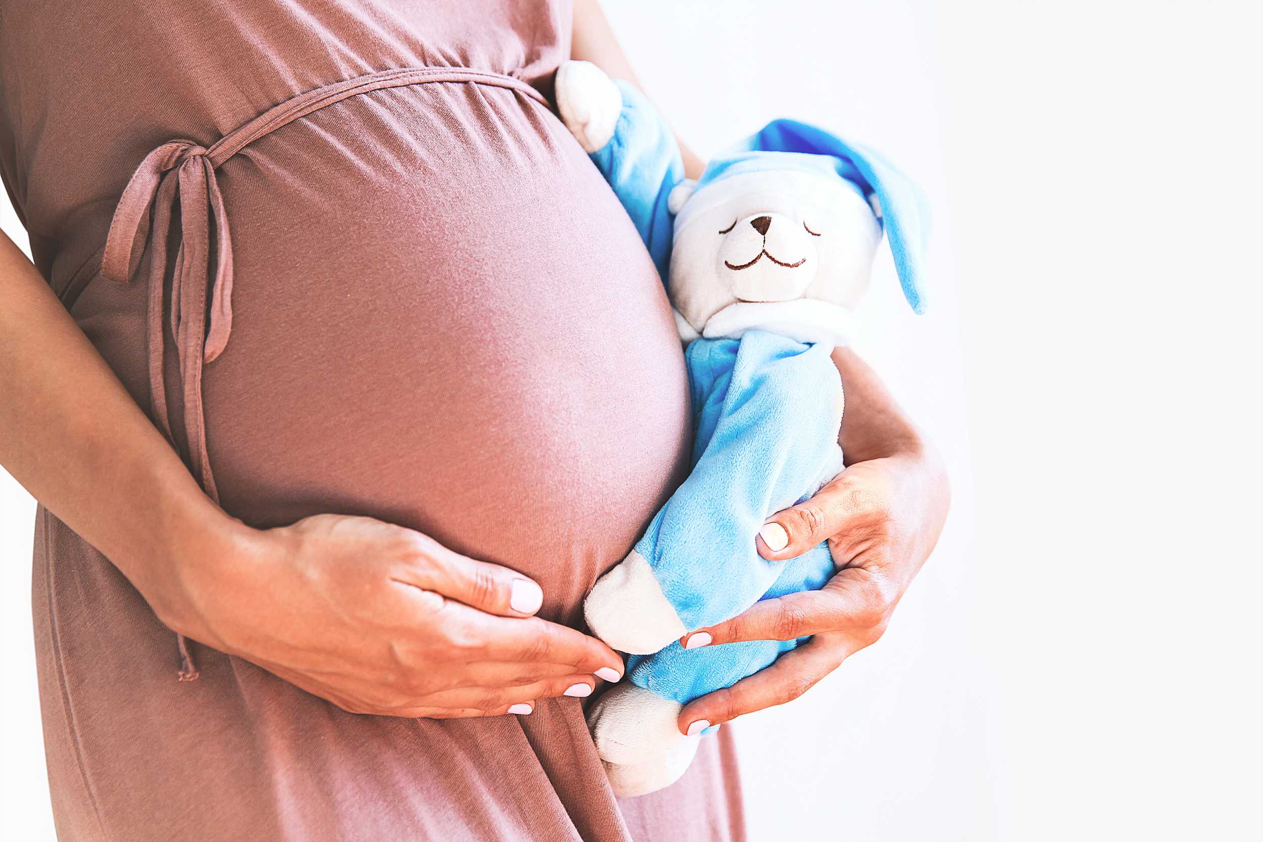 pregnant woman with a toy in hand