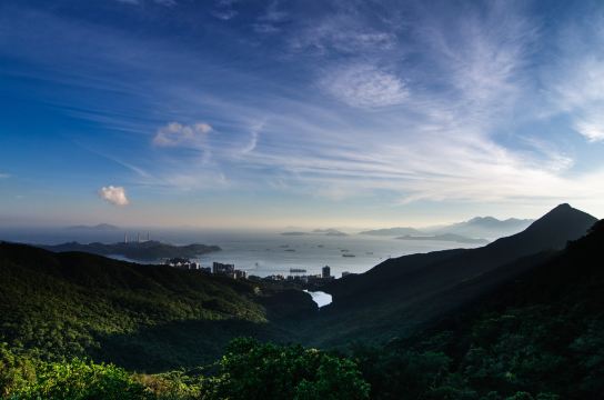 Green hills and coastline seen from Victoria Peak in Hong Kong, with the harbour and outlying islands beyond