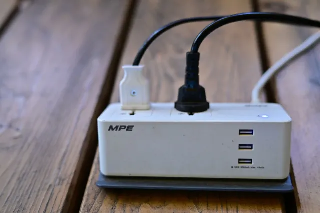 Power strip with USB ports and a plug adapter