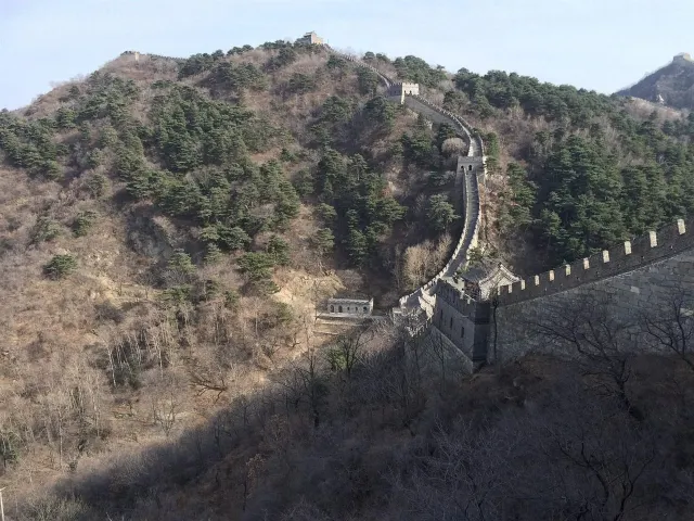 The Great Wall of China winding across forested hills near Beijing