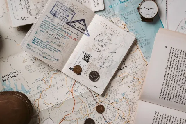 Passports, boarding passes and a folded map laid out on a table