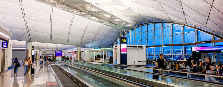 Step into the vibrant world of an international airport terminal, where the sleek jet bridge awaits to whisk you away. Watch as fellow travellers embark on their exciting journeys, all part of the seamless departure and boarding process.
