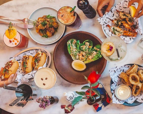A table in a cafe filled with food