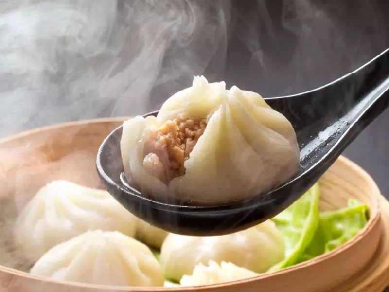 Steamed soup dumplings, xiaolongbao, filled with savory meat and broth