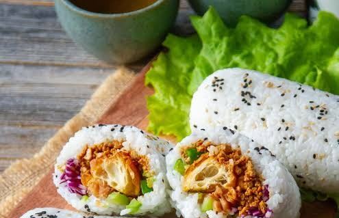 Sticky rice rolls, ci fan tuan, filled with crispy fried dough and vegetables