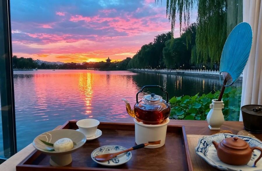 Chinese tea set overlooking a lake at sunset in Beijing