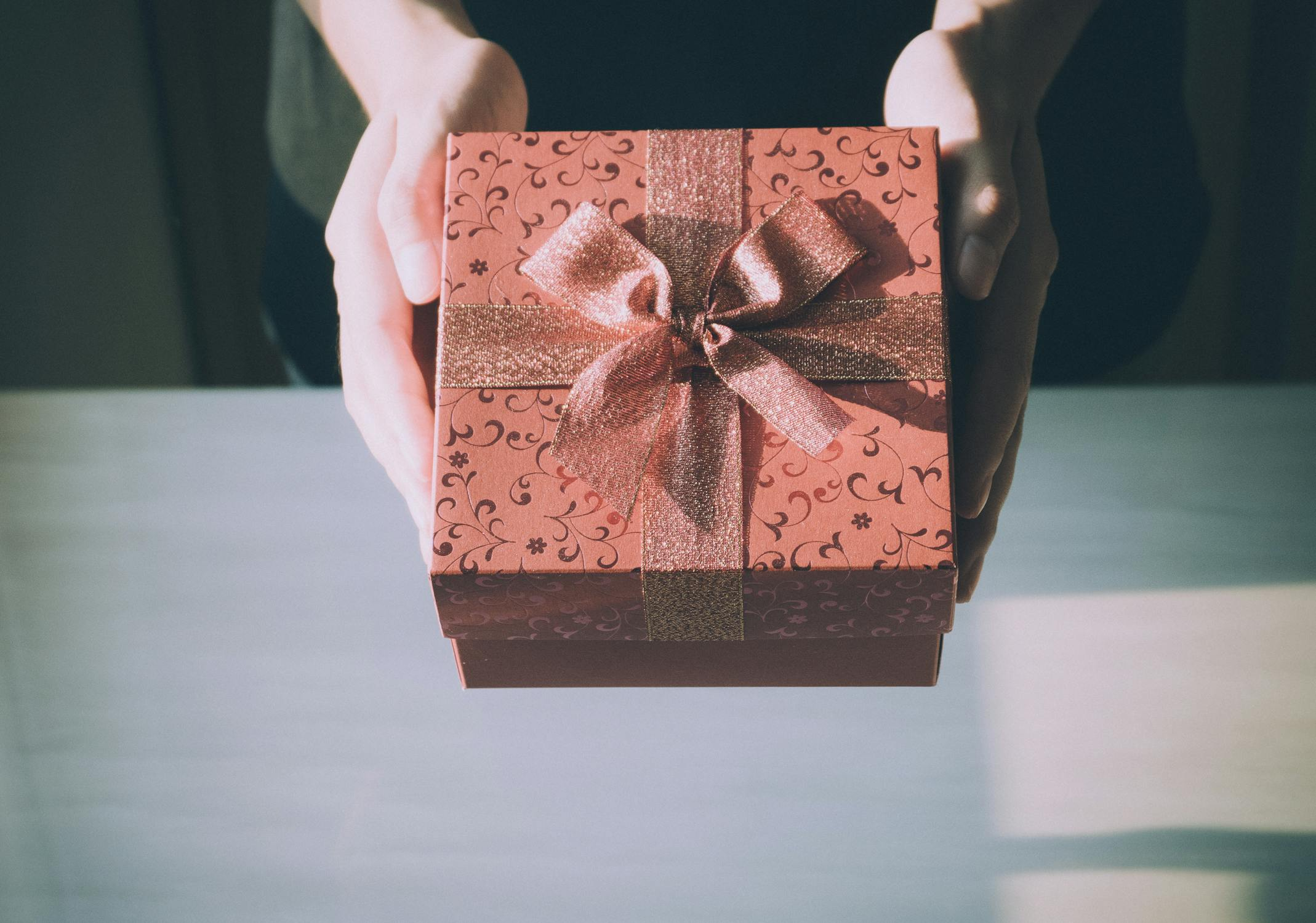 A person holding a gift out