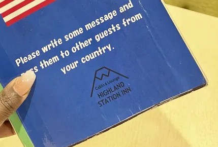 Guestbook at Highland Station Inn with messages from travelers