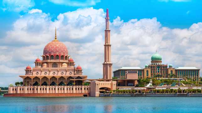 The lakeside Putra Mosque in Putrajaya, with its iconic pink dome and minaret