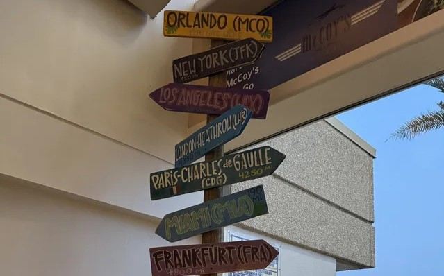 Colorful airport signpost showing directions to Orlando and other destinations