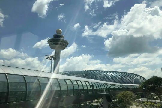 Changi Airport control tower rising above the terminal roof