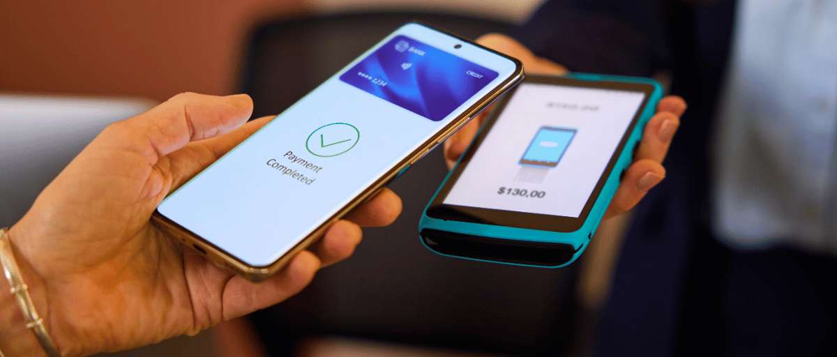 Person paying with their mobile phone using a contactless payment terminal
