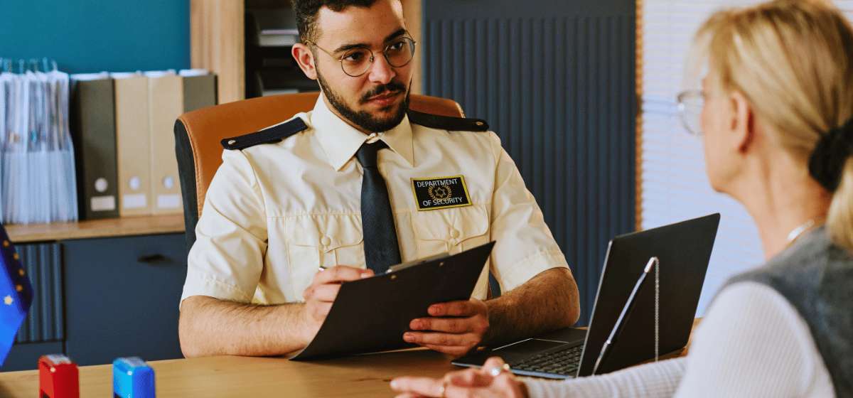 An official checking a traveller's documents at an immigration control office