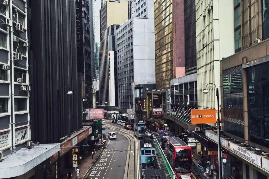 Central Hong Kong street with trams and double-decker buses