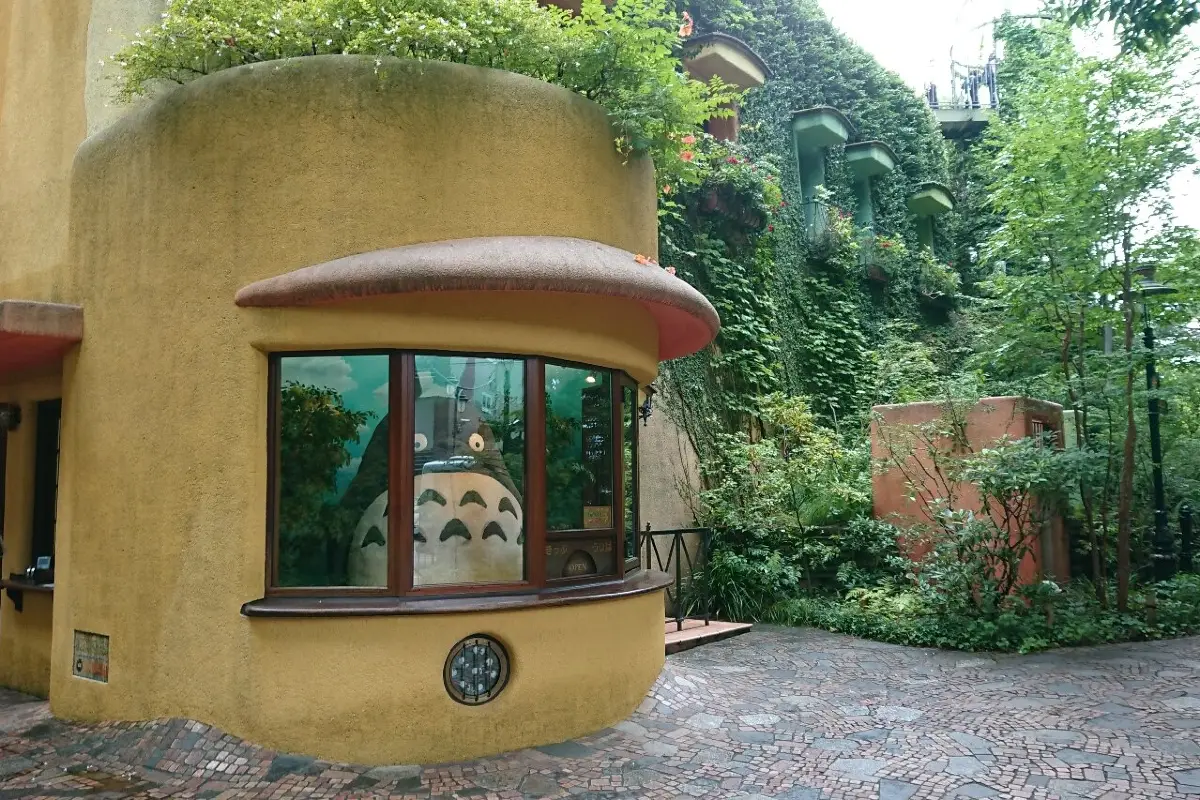 Totoro sitting in a room or something like a ticketing counter