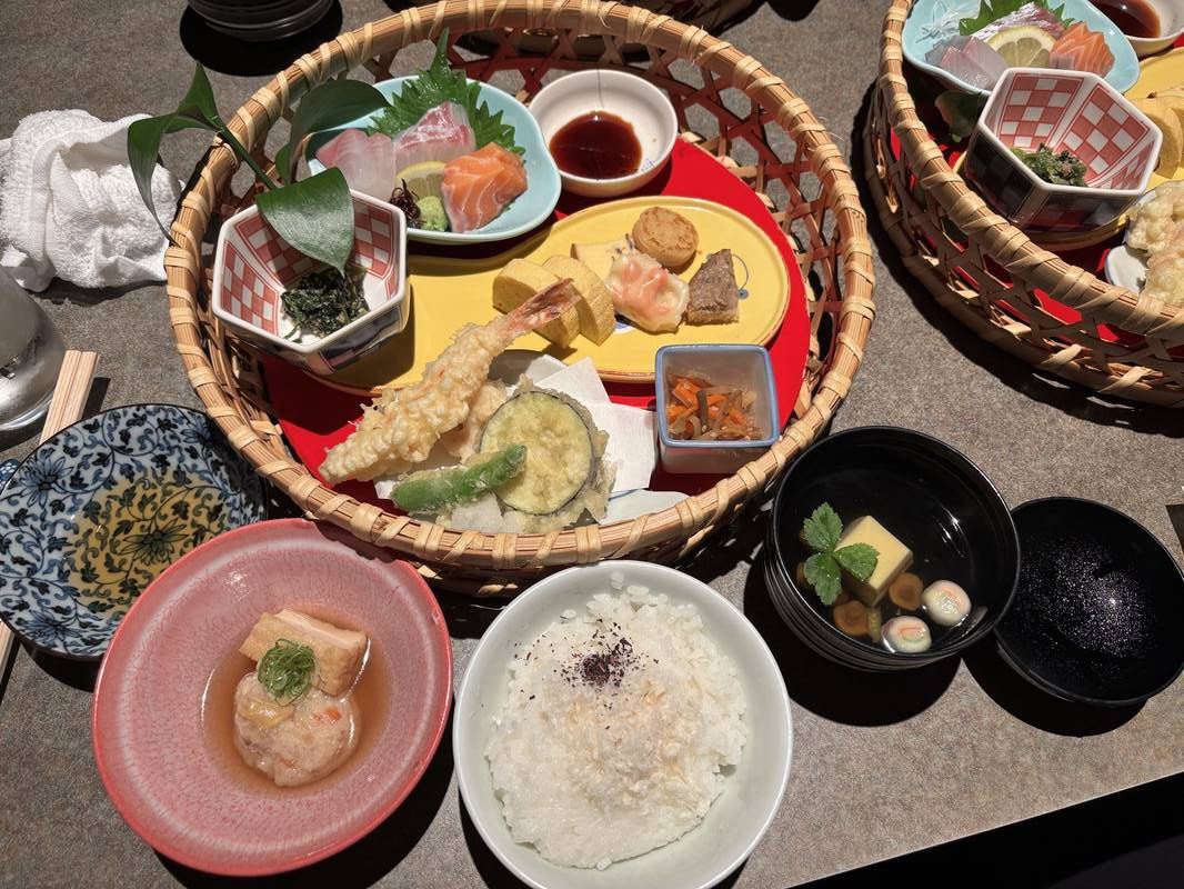 Japanese meal with tempura, sashimi, rice, and assorted side dishes
