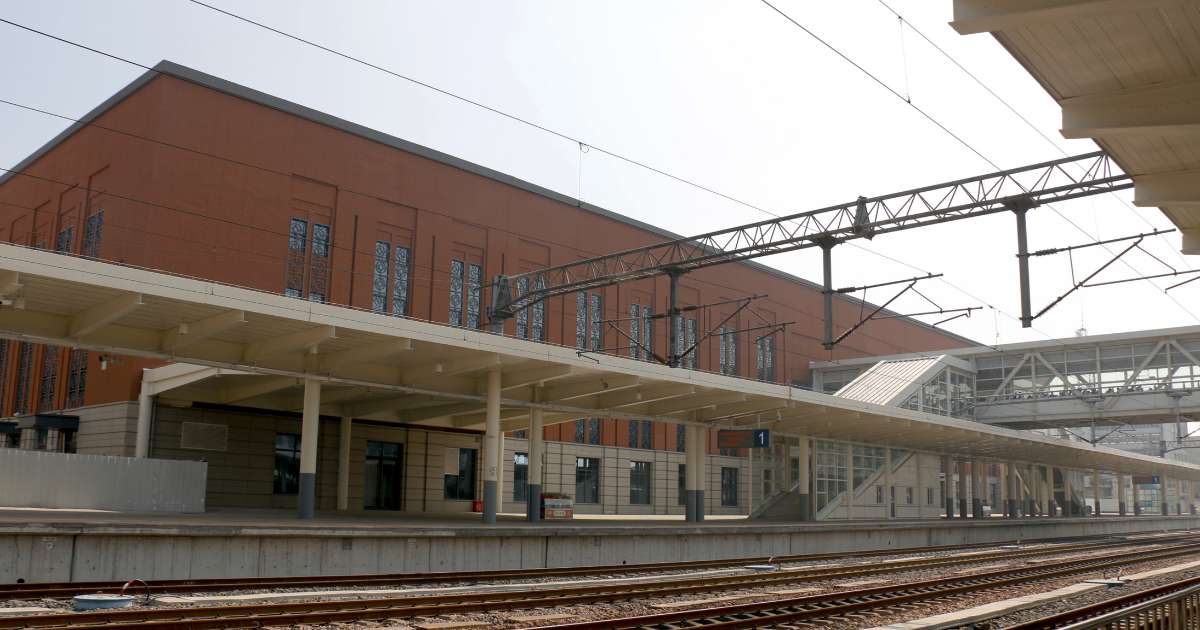 Modern railway station building and a train platform