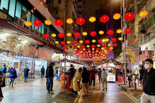 Temple Street Night Market lined with colorful lanterns in Yau Ma Tei