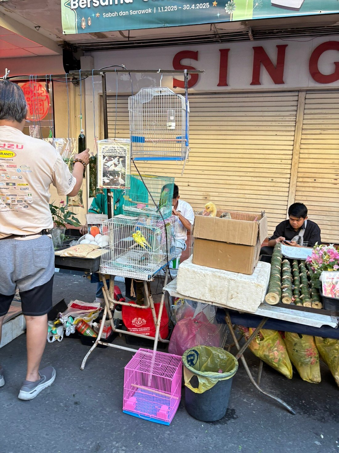 A merchant selling random animals by the side of the road