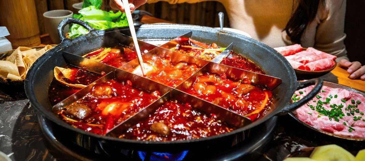 Sichuan hot pot with spicy broth, meat and vegetables