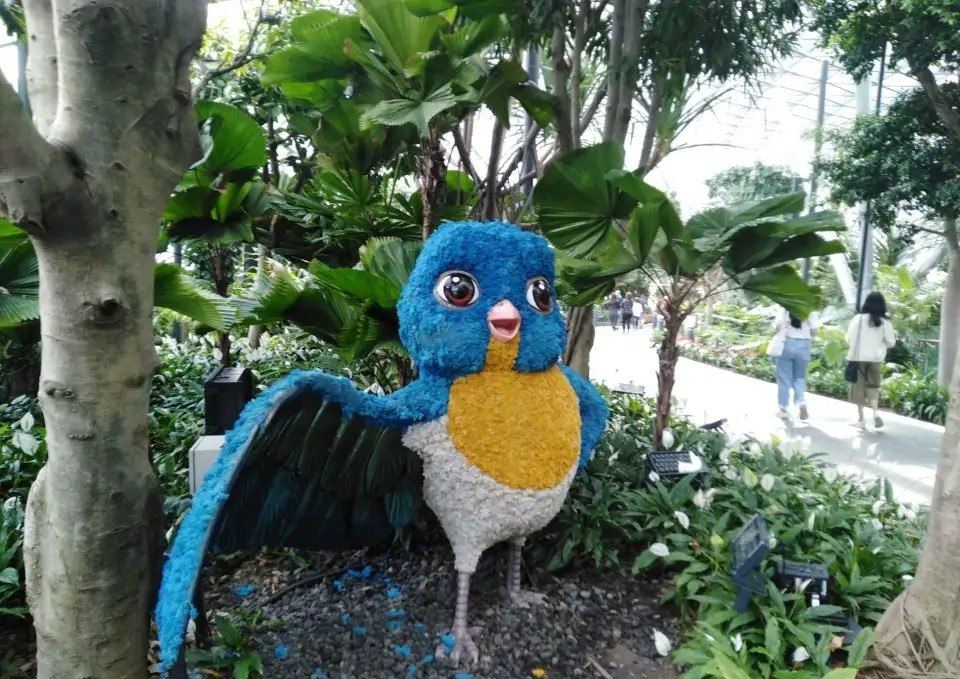 Colorful bird-shaped topiary in the indoor gardens at Jewel Changi Airport