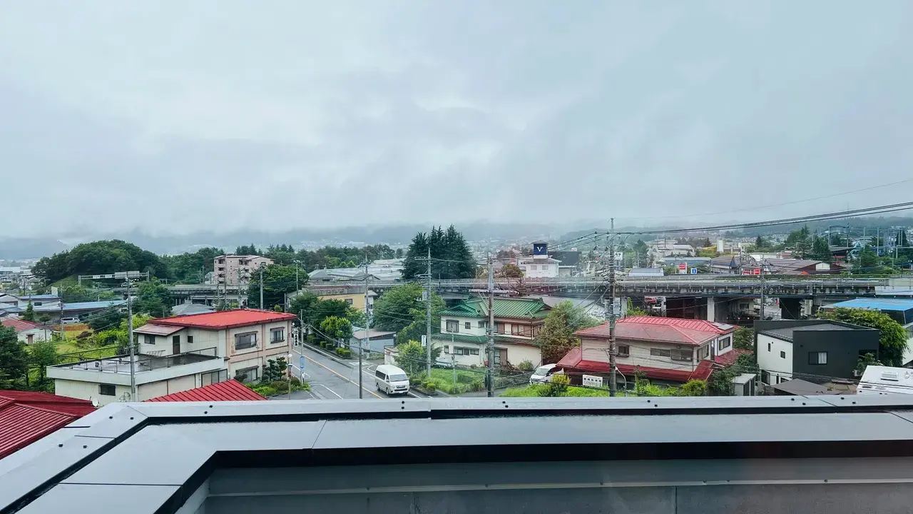 Residential view around Lake Kawaguchi beneath cloudy mountain skies