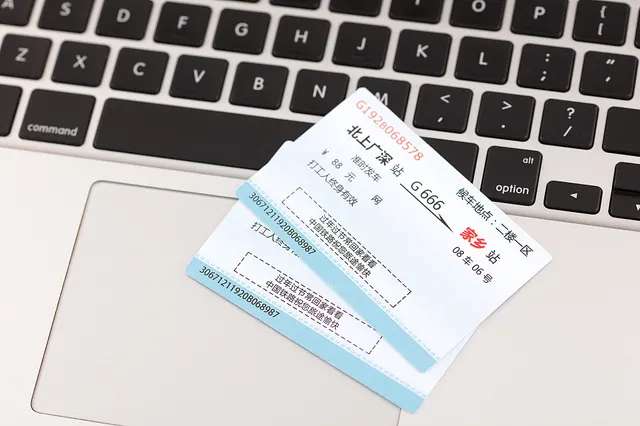 Train tickets placed on a laptop keyboard