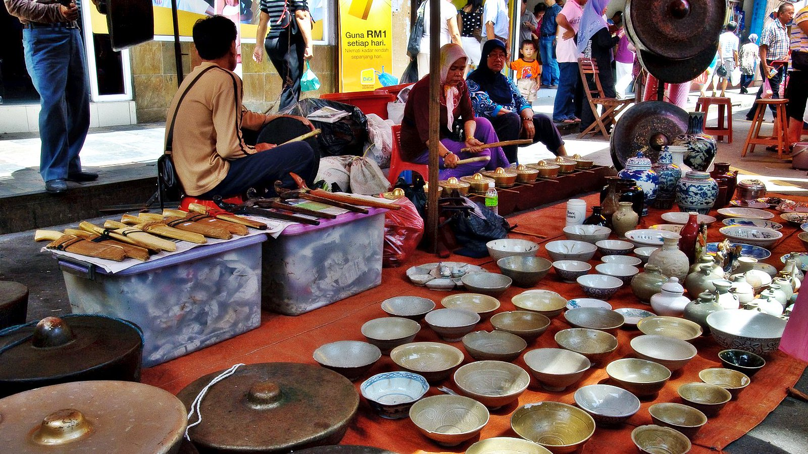 A lady selling gongs in the gaya street market